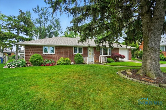 2519 Melva Ct, Toledo, OH 43611 - ranch-style home with brick siding, an attached garage, a front lawn, and concrete driveway