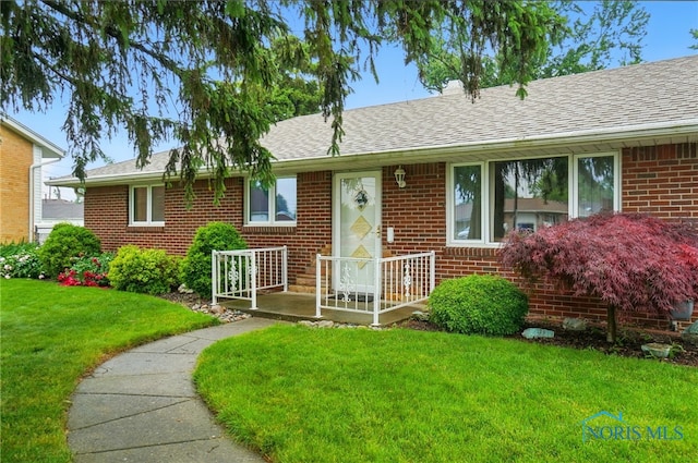 2519 Melva Ct, Toledo, OH 43611 - single story home with brick siding, a front yard, and roof with shingles