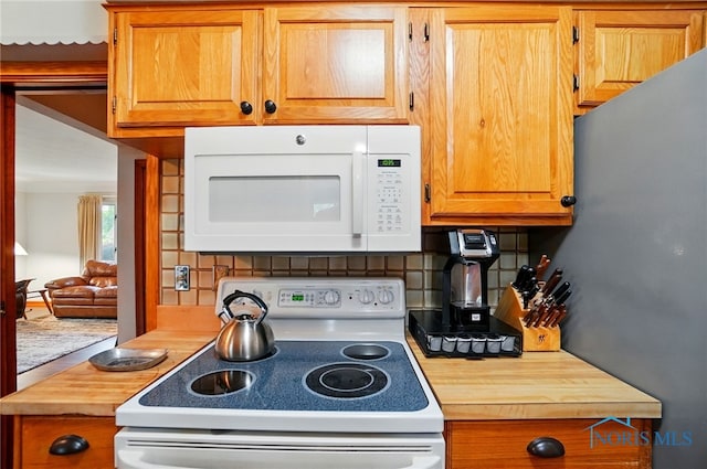 2519 Melva Ct, Toledo, OH 43611 - kitchen with white appliances, decorative backsplash, wooden counters, and brown cabinetry