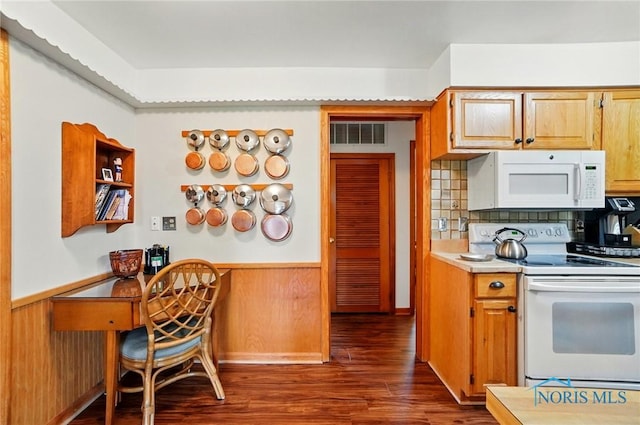 2519 Melva Ct, Toledo, OH 43611 - kitchen featuring white appliances, dark wood-type flooring, wainscoting, light countertops, and wood walls