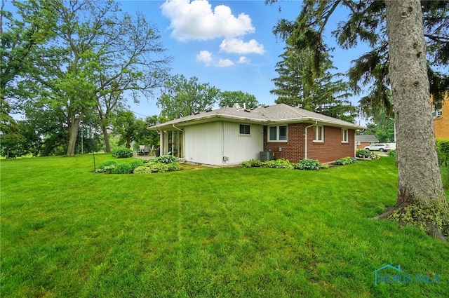 2519 Melva Ct, Toledo, OH 43611 - view of side of property featuring a yard and brick siding