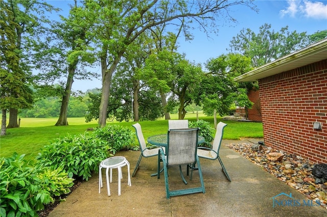 2519 Melva Ct, Toledo, OH 43611 - view of patio with view of wooded area and outdoor dining space