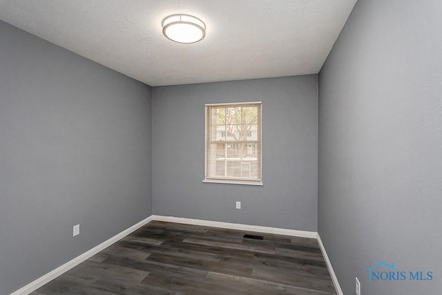 2509 Orchard Hills Blvd, Toledo, OH 43615 - spare room featuring baseboards and dark wood finished floors