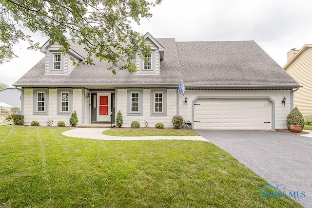 5226 Summer Dr, Sylvania, OH 43560 - new england style home with asphalt driveway, roof with shingles, a front yard, and an attached garage