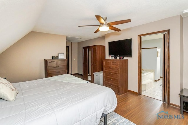 5226 Summer Dr, Sylvania, OH 43560 - bedroom with wood finished floors, vaulted ceiling, and ceiling fan