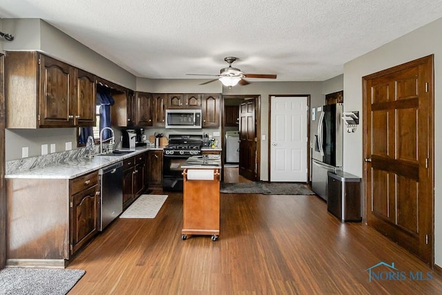 5226 Summer Dr, Sylvania, OH 43560 - kitchen with stainless steel appliances, a center island, light countertops, ceiling fan, and dark wood finished floors