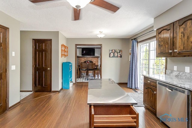 5226 Summer Dr, Sylvania, OH 43560 - kitchen with stainless steel dishwasher, wood finished floors, a textured ceiling, ceiling fan, and dark brown cabinetry