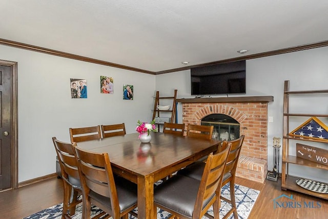 5226 Summer Dr, Sylvania, OH 43560 - dining room with ornamental molding, wood finished floors, and a fireplace