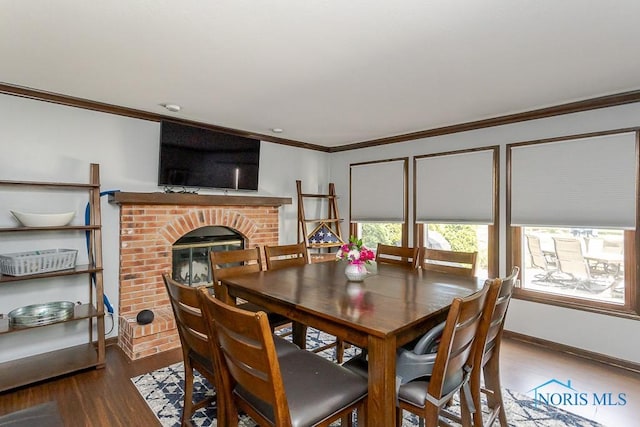 5226 Summer Dr, Sylvania, OH 43560 - dining area featuring crown molding, wood finished floors, and a brick fireplace