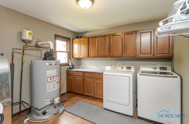 5226 Summer Dr, Sylvania, OH 43560 - laundry area with water heater, cabinet space, washer and dryer, and light wood finished floors