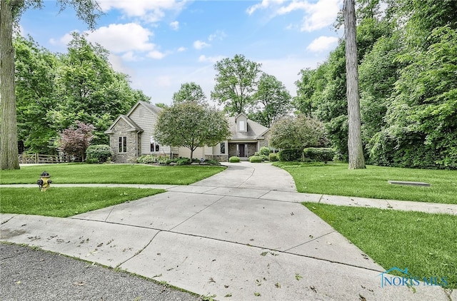 4068 Deer Ravine Ct, Maumee, OH 43537 - view of front of property featuring a front lawn, stone siding, and concrete driveway