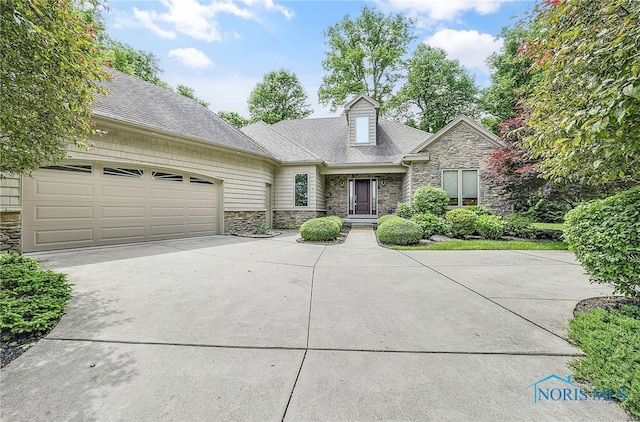 4068 Deer Ravine Ct, Maumee, OH 43537 - view of front facade with stone siding, concrete driveway, a garage, and a shingled roof