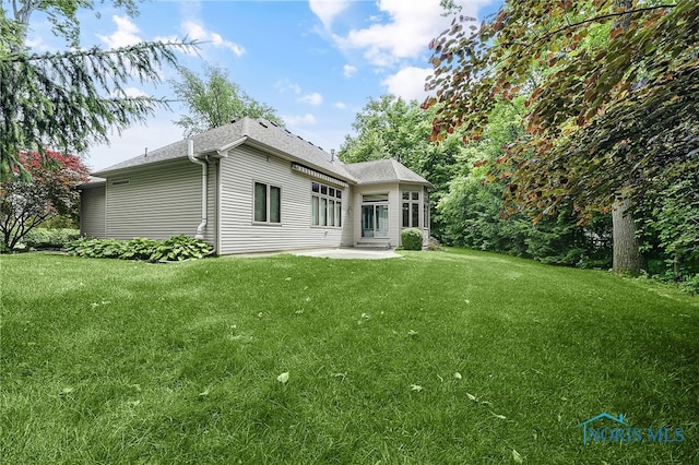 4068 Deer Ravine Ct, Maumee, OH 43537 - back of house featuring a patio, a yard, and a shingled roof