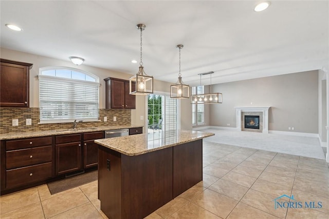4382 Morgan Pl, Perrysburg, OH 43551 - kitchen featuring a kitchen island, stainless steel dishwasher, dark brown cabinets, light colored carpet, and backsplash
