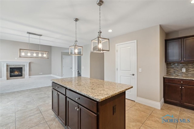 4382 Morgan Pl, Perrysburg, OH 43551 - kitchen with light tile patterned flooring, dark brown cabinetry, light stone counters, and recessed lighting
