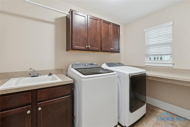 4382 Morgan Pl, Perrysburg, OH 43551 - laundry area with washing machine and dryer, cabinet space, and light tile patterned flooring