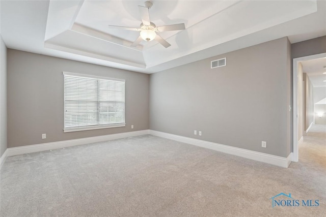 4382 Morgan Pl, Perrysburg, OH 43551 - spare room with a tray ceiling, carpet, and a ceiling fan