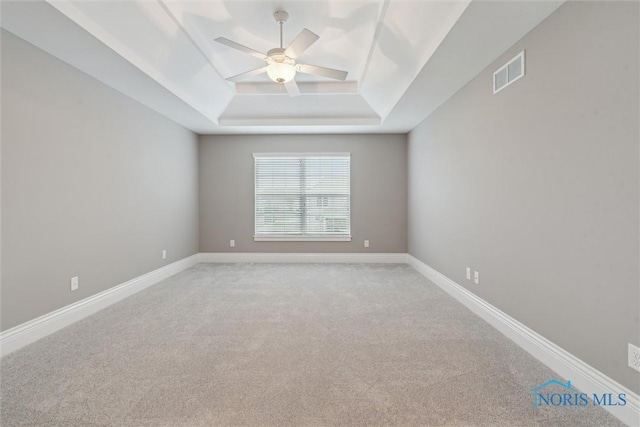 4382 Morgan Pl, Perrysburg, OH 43551 - spare room featuring a tray ceiling, a ceiling fan, and light carpet