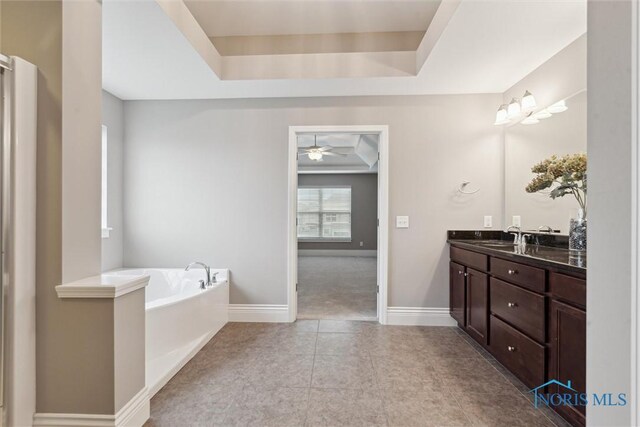 4382 Morgan Pl, Perrysburg, OH 43551 - bathroom featuring a raised ceiling, vanity, a garden tub, a ceiling fan, and tile patterned floors