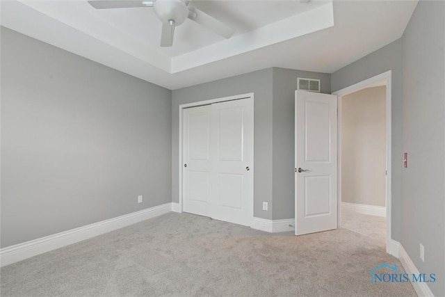 4382 Morgan Pl, Perrysburg, OH 43551 - unfurnished bedroom featuring carpet flooring, a closet, a raised ceiling, and ceiling fan