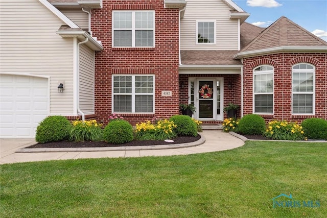 4382 Morgan Pl, Perrysburg, OH 43551 - traditional-style house featuring brick siding, a front yard, a shingled roof, and an attached garage