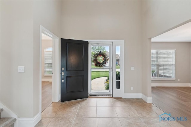 4382 Morgan Pl, Perrysburg, OH 43551 - foyer featuring a towering ceiling, stairs, and light tile patterned flooring