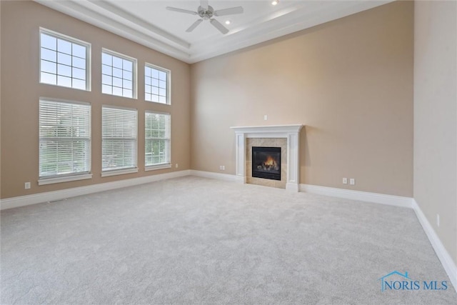 4382 Morgan Pl, Perrysburg, OH 43551 - unfurnished living room featuring light colored carpet, a ceiling fan, a tiled fireplace, a towering ceiling, and recessed lighting