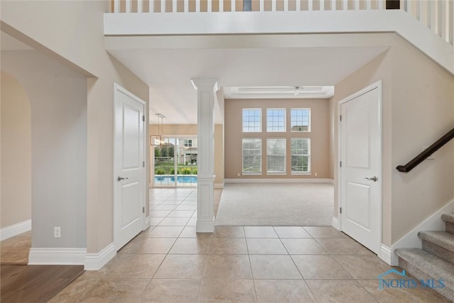 4382 Morgan Pl, Perrysburg, OH 43551 - entryway with ornate columns, stairway, light carpet, and light tile patterned floors
