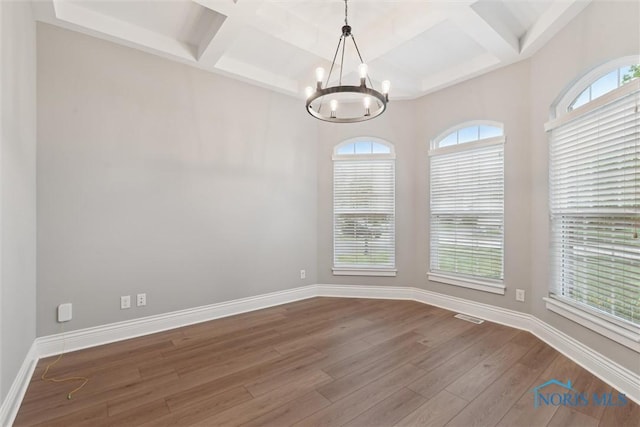 4382 Morgan Pl, Perrysburg, OH 43551 - empty room featuring coffered ceiling, a chandelier, hardwood / wood-style floors, plenty of natural light, and beamed ceiling