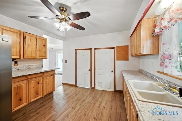 356 S Belmore St, Leipsic, OH 45856 - kitchen with freestanding refrigerator, light wood-style flooring, and light countertops