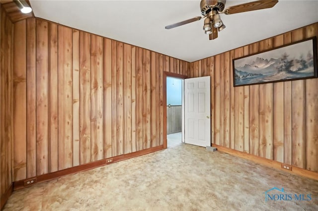 356 S Belmore St, Leipsic, OH 45856 - carpeted empty room with ceiling fan and wood walls