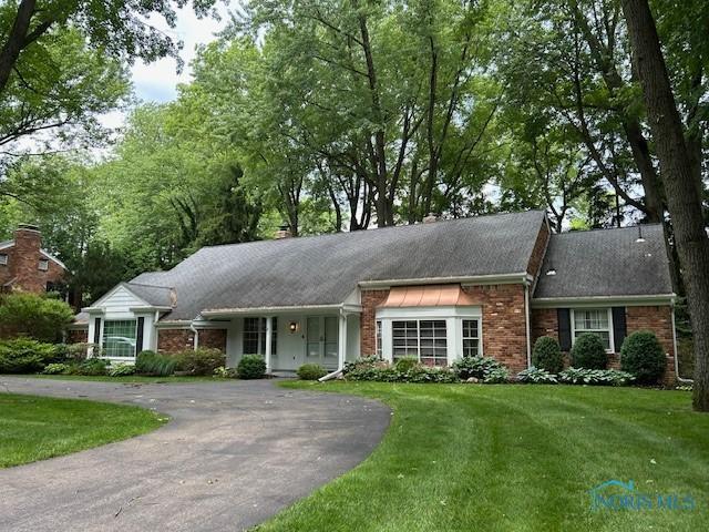 3432 Corey Rd, Toledo, OH 43615 - ranch-style home featuring a front lawn, driveway, and brick siding