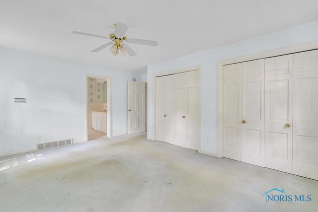 3432 Corey Rd, Toledo, OH 43615 - unfurnished bedroom with carpet flooring, two closets, ceiling fan, and ensuite bath
