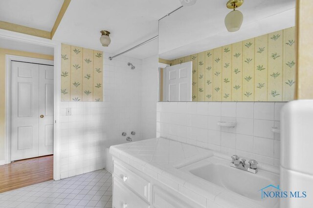 3432 Corey Rd, Toledo, OH 43615 - bathroom with tile walls, vanity, wallpapered walls, tile patterned floors, and a shower