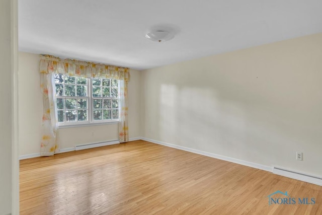 3432 Corey Rd, Toledo, OH 43615 - spare room featuring a baseboard radiator, wood finished floors, and baseboard heating