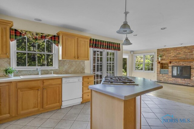 3432 Corey Rd, Toledo, OH 43615 - kitchen with dishwasher, stainless steel gas stovetop, light countertops, and backsplash