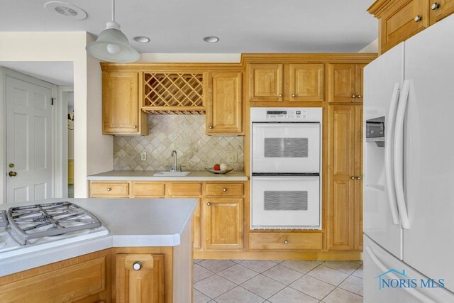 3432 Corey Rd, Toledo, OH 43615 - kitchen with white appliances, light countertops, decorative backsplash, light tile patterned floors, and hanging light fixtures