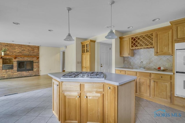 3432 Corey Rd, Toledo, OH 43615 - kitchen with stainless steel gas cooktop, light tile patterned floors, a center island, light countertops, and recessed lighting