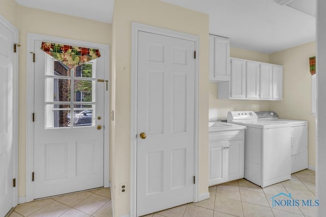 3432 Corey Rd, Toledo, OH 43615 - laundry area featuring washer and clothes dryer, cabinet space, and light tile patterned floors