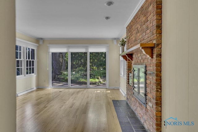 3432 Corey Rd, Toledo, OH 43615 - unfurnished living room featuring ornamental molding, wood finished floors, a fireplace, and a baseboard heating unit