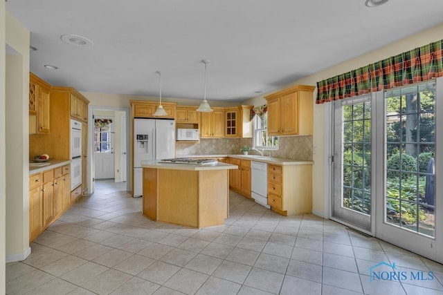 3432 Corey Rd, Toledo, OH 43615 - kitchen featuring white appliances, light countertops, a center island, backsplash, and light tile patterned floors