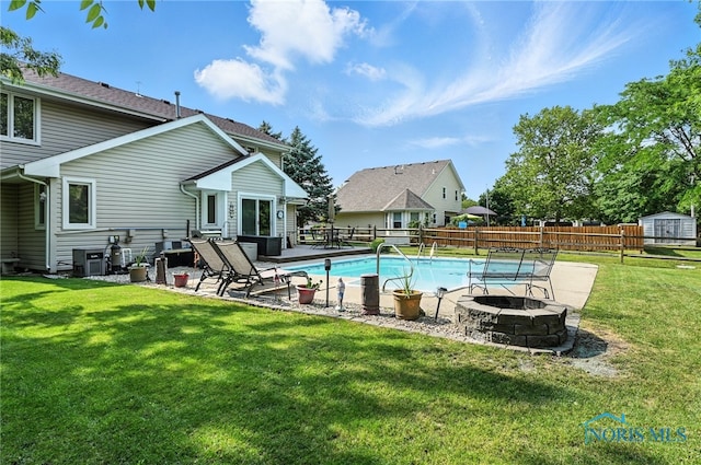 1780 Lexington Dr, Perrysburg, OH 43551 - view of swimming pool with an outdoor fire pit, a patio area, a fenced backyard, and a storage unit