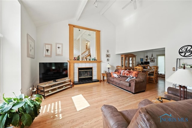1780 Lexington Dr, Perrysburg, OH 43551 - living room with wood finished floors, a ceiling fan, a chandelier, and a tile fireplace