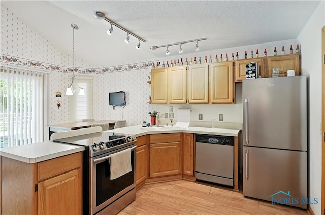 1780 Lexington Dr, Perrysburg, OH 43551 - kitchen featuring stainless steel appliances, a peninsula, wallpapered walls, light countertops, and light wood-type flooring