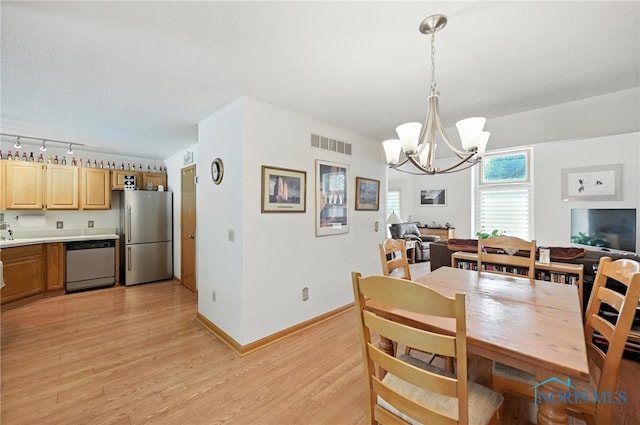 1780 Lexington Dr, Perrysburg, OH 43551 - dining space with a chandelier and light wood-style flooring