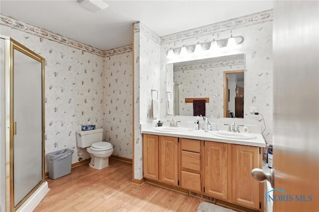 1780 Lexington Dr, Perrysburg, OH 43551 - bathroom featuring wood finished floors, double vanity, a shower stall, and wallpapered walls