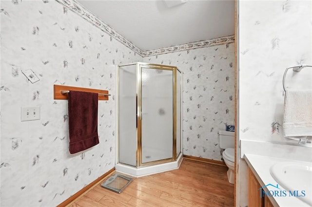 1780 Lexington Dr, Perrysburg, OH 43551 - full bathroom featuring wood finished floors, a shower stall, vanity, and wallpapered walls