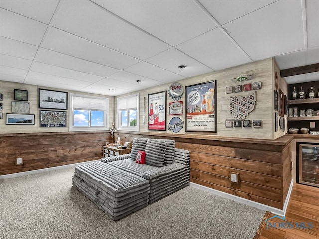 5425 Tulane Ave, Toledo, OH 43611 - sitting room featuring beverage cooler, a drop ceiling, wood walls, and a bar