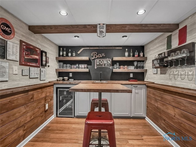 5425 Tulane Ave, Toledo, OH 43611 - indoor bar with wine cooler, beam ceiling, light wood-style floors, wood walls, and recessed lighting