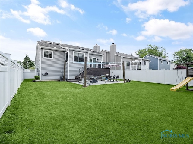 5425 Tulane Ave, Toledo, OH 43611 - back of house featuring a patio, a fenced backyard, and a playground